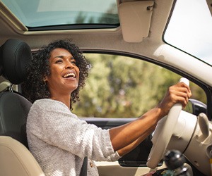 Woman smiling while driving