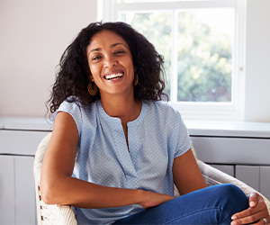 Woman with dental crown in Portland smiling