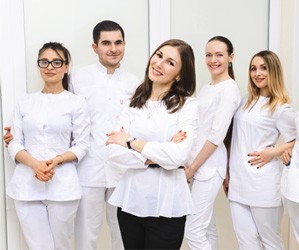 A team of dental office staff smiling 