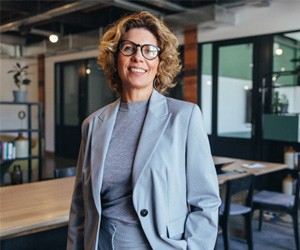 Woman smiling while standing in office