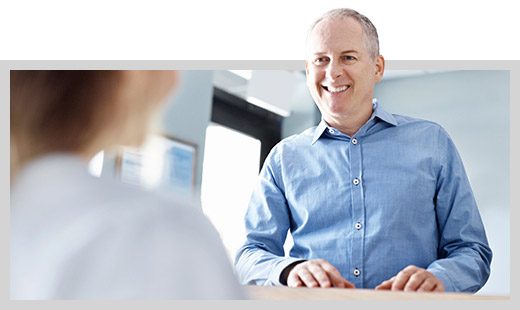 Man checking in at reception desk