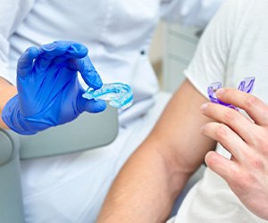 Dentist shows patient mouthguards