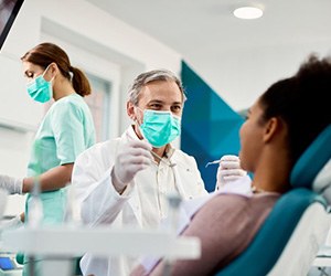 Dentist treats patient