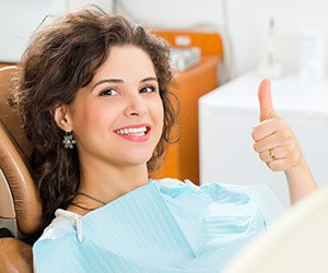 Young woman giving thumbs up