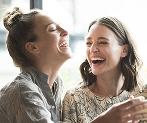 Two women laughing together