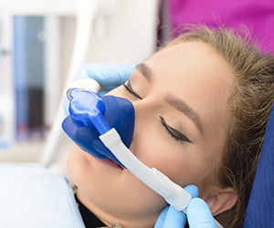 Woman in dental chair with nitrous oxide mask
