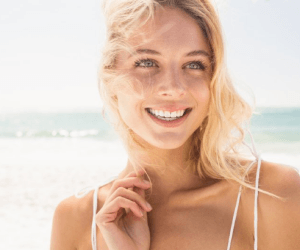 A woman smiling at the beach
