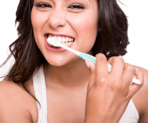 A woman brushing her teeth