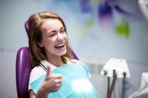 woman smiling sitting dentist chair