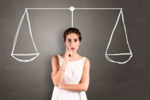 woman with scale trying to decide between dental insurance and discount plan