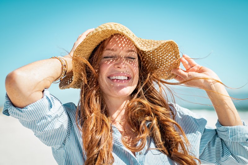 woman smiling on beach during summer vacation