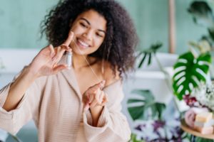 Smiling woman getting out dental floss for flossing