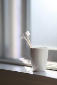 Toothbrushes in plastic cup