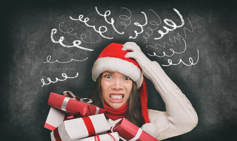 woman in Santa hat stressing out over holidays