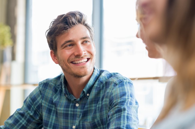 Patient smiling with confidence after cosmetic dentistry